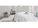 Comfortable bedroom with white bedding, accent chair, and stylish decor at 1924 Browns Mill Se Rd, Atlanta, GA 30315