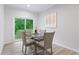 Bright dining area features a glass table, stylish chairs, and sliding glass doors to the outdoors at 1924 Browns Mill Se Rd, Atlanta, GA 30315