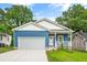 Charming blue home with a welcoming front porch and a two-car attached garage at 1924 Browns Mill Se Rd, Atlanta, GA 30315