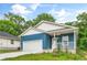 Charming blue house with a two-car garage, white trim, and well-maintained front lawn at 1924 Browns Mill Se Rd, Atlanta, GA 30315