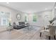 Bright living room featuring modern decor, wood floors, and large windows at 1924 Browns Mill Se Rd, Atlanta, GA 30315