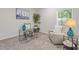 Cozy office space featuring a comfortable sofa, glass desk, and natural lighting at 1924 Browns Mill Se Rd, Atlanta, GA 30315