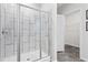 Modern tiled shower with glass enclosure and updated fixtures, plus a peek at closet beyond at 1924 Browns Mill Se Rd, Atlanta, GA 30315