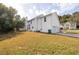 Large grassy backyard with a home's exterior including the 2 car garage at 4230 Waldrop Hills Ter, Decatur, GA 30034