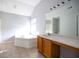 Bright bathroom features a large vanity, soaking tub and tile floors at 4230 Waldrop Hills Ter, Decatur, GA 30034