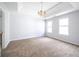 Spacious bedroom features a tray ceiling, neutral paint, and large windows at 4230 Waldrop Hills Ter, Decatur, GA 30034