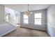 Dining room with carpeted floors, decorative chandelier and a staircase view at 4230 Waldrop Hills Ter, Decatur, GA 30034