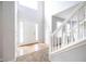 Bright foyer featuring tiled flooring, a staircase with white railing, and a soaring ceiling at 4230 Waldrop Hills Ter, Decatur, GA 30034