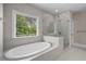 A relaxing bathroom with a large soaking tub and glass enclosed shower at 4900 Kentwood Dr, Marietta, GA 30068