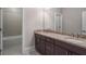 Bathroom with double vanity, granite countertop, and tiled shower at 4900 Kentwood Dr, Marietta, GA 30068
