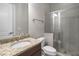 This bathroom boasts a granite countertop, a clear glass shower and a white toilet at 4900 Kentwood Dr, Marietta, GA 30068