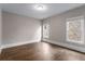 Bedroom with hardwood floors, two windows, and neutral walls at 4900 Kentwood Dr, Marietta, GA 30068