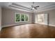 An expansive bedroom with gleaming hardwood floors and windows overlooking the greenery at 4900 Kentwood Dr, Marietta, GA 30068