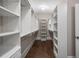 Spacious walk-in closet with custom shelving and dark wood floors at 4900 Kentwood Dr, Marietta, GA 30068