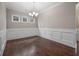 Elegant dining room with beautiful wainscoting and a chandelier for ambient lighting at 4900 Kentwood Dr, Marietta, GA 30068