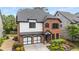 Beautiful two-story home featuring a two-car garage, brick accents and manicured landscaping at 4900 Kentwood Dr, Marietta, GA 30068