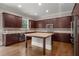 Gourmet kitchen boasts dark wood cabinetry, granite countertops, and stainless steel appliances at 4900 Kentwood Dr, Marietta, GA 30068