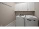 A laundry room with a large, front-loading washer and a large, front-loading dryer at 4900 Kentwood Dr, Marietta, GA 30068