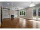 Spacious living room featuring hardwood floors, built-in shelves, and a cozy fireplace at 4900 Kentwood Dr, Marietta, GA 30068