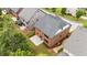 Stunning brick home featuring a concrete patio and lush green landscaping at 4900 Kentwood Dr, Marietta, GA 30068