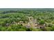 An aerial shot of a neighborhood nestled in a lush, green, wooded area at 7505 Antique Barn Ave, Cumming, GA 30041