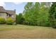 A lush, green backyard offers a serene escape, enhanced by mature trees and thoughtful landscaping at 7505 Antique Barn Ave, Cumming, GA 30041