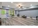 Finished basement with wood-look floors, pot lights, and a walk-out door for easy access to the outdoors at 7505 Antique Barn Ave, Cumming, GA 30041