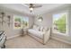Cozy bedroom with a trundle bed, nice windows, and a ceiling fan at 7505 Antique Barn Ave, Cumming, GA 30041