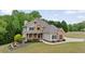 Charming two-story home with a well-manicured lawn and beautiful landscaping, perfect for a Gathering at 7505 Antique Barn Ave, Cumming, GA 30041