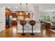 Modern kitchen featuring stainless steel appliances, a breakfast bar, and hardwood floors at 7505 Antique Barn Ave, Cumming, GA 30041