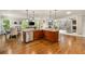 A stylish kitchen with stainless steel appliances, granite countertops, and an island with a breakfast bar at 7505 Antique Barn Ave, Cumming, GA 30041