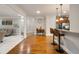 Open-concept kitchen featuring granite countertops, hardwood floors, stainless appliances, and modern pendant lighting at 7505 Antique Barn Ave, Cumming, GA 30041