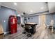 A spacious room showcasing a charming bar island, complemented by a stylish retro refrigerator and fixtures at 7505 Antique Barn Ave, Cumming, GA 30041