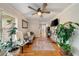 Comfortable living room featuring hardwood floors, neutral walls, and abundant natural light from a large window at 7505 Antique Barn Ave, Cumming, GA 30041