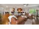 Spacious living room with hardwood floors, seamlessly connecting the kitchen and seating areas at 7505 Antique Barn Ave, Cumming, GA 30041