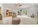 Open living room with an ottoman, plush seating, and access to the kitchen and outdoor deck at 7505 Antique Barn Ave, Cumming, GA 30041