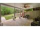 A covered patio offers a serene outdoor space with a ceiling fan and scenic view of the landscaped backyard at 7505 Antique Barn Ave, Cumming, GA 30041