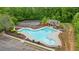 Community pool and tennis court surrounded by lush greenery in a residential area at 7505 Antique Barn Ave, Cumming, GA 30041
