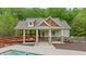A charming pool house with stone accents offers convenient access to the pool at 7505 Antique Barn Ave, Cumming, GA 30041