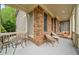 Relaxing front porch with seating, offering a serene view of the landscaped yard at 7505 Antique Barn Ave, Cumming, GA 30041