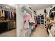 Organized walk-in closet with ample shelving and hanging space for clothes and storage at 7505 Antique Barn Ave, Cumming, GA 30041
