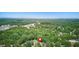 Expansive aerial view of the home's location nestled among a lush green, heavily-wooded landscape at 8136 Connally Dr, Douglasville, GA 30134