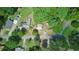 Overhead view of a home showing its roofline, the driveway, road, and surrounding mature trees at 8136 Connally Dr, Douglasville, GA 30134