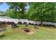 The private backyard has a cozy seating area with a fire pit and a white fence at 8136 Connally Dr, Douglasville, GA 30134