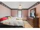 Bedroom with hardwood floors, a window, dresser and single bed at 8136 Connally Dr, Douglasville, GA 30134