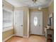 Inviting entryway featuring a decorative front door, window with blinds, and wood floors at 8136 Connally Dr, Douglasville, GA 30134