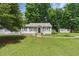 Beautiful single-story home with a well-manicured lawn, blue shutters, and a storage shed in the backyard at 8136 Connally Dr, Douglasville, GA 30134