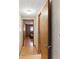 Hallway with hardwood floors leading to bedrooms, features a door opening into the space at 8136 Connally Dr, Douglasville, GA 30134