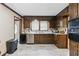Traditional kitchen featuring dark cabinets, stainless steel appliances, and a window over the sink at 8136 Connally Dr, Douglasville, GA 30134