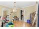 A room with hardwood floors and a chandelier. Boxes are piled against one wall at 8136 Connally Dr, Douglasville, GA 30134